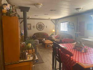 Dining area with wood-type flooring, a wood stove, and a textured ceiling