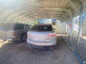 View of parking featuring a carport