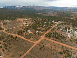 Aerial view of sparsely populated area with a mountainous background and a desert landscape