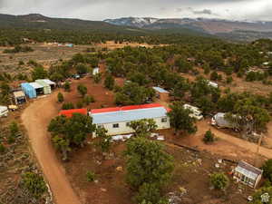 Aerial view of property's location featuring a mountain backdrop and rural landscape