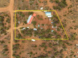 Aerial view of sparsely populated area featuring property boundaries highlighted and a desert landscape