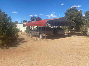 View of parking with a carport and driveway