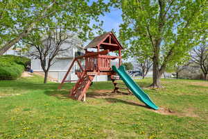 View of playground with a lawn