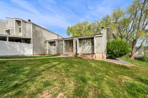 View of front of house featuring a chimney and a front yard
