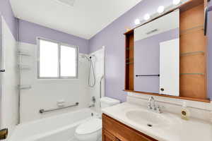 Bathroom with vanity and bathtub / shower combination