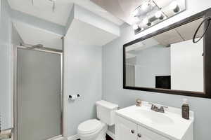 Bathroom featuring vanity and a stall shower