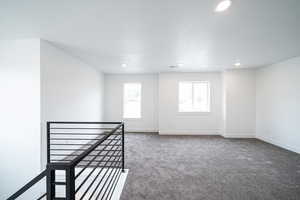 Carpeted spare room with recessed lighting