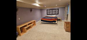 Bedroom featuring light colored carpet and recessed lighting