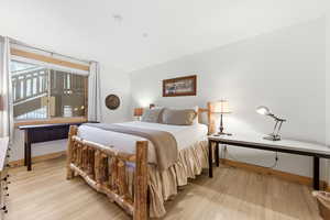 Bedroom with light wood-style floors and baseboards