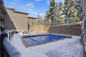 Community pool with a patio and grilling area