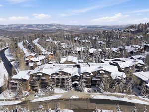 Snowy aerial view featuring a mountain view
