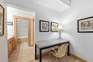 Office area featuring light wood-type flooring and baseboards