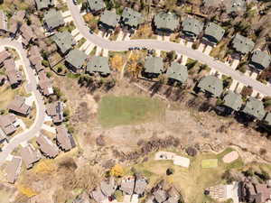 Aerial view of property and surrounding area featuring nearby suburban area
