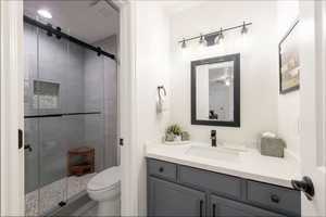 Bathroom featuring vanity and a shower stall