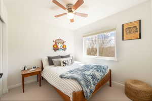Bedroom featuring a ceiling fan and carpet floors