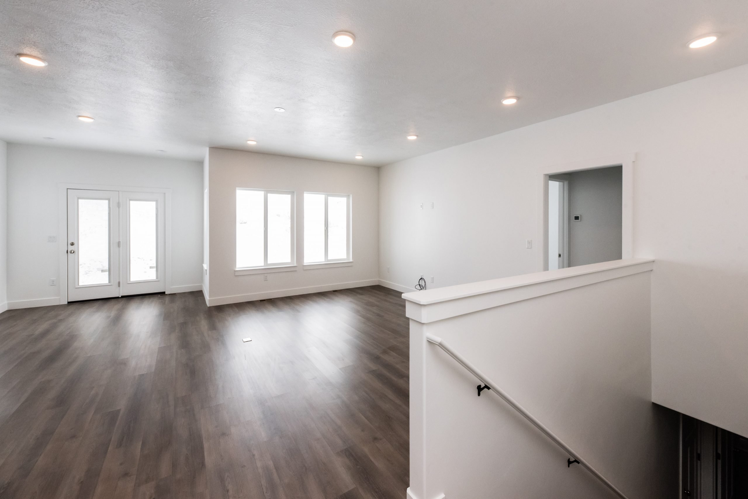 Spare room featuring dark wood-style flooring and recessed lighting