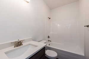 Bathroom featuring vanity and washtub / shower combination