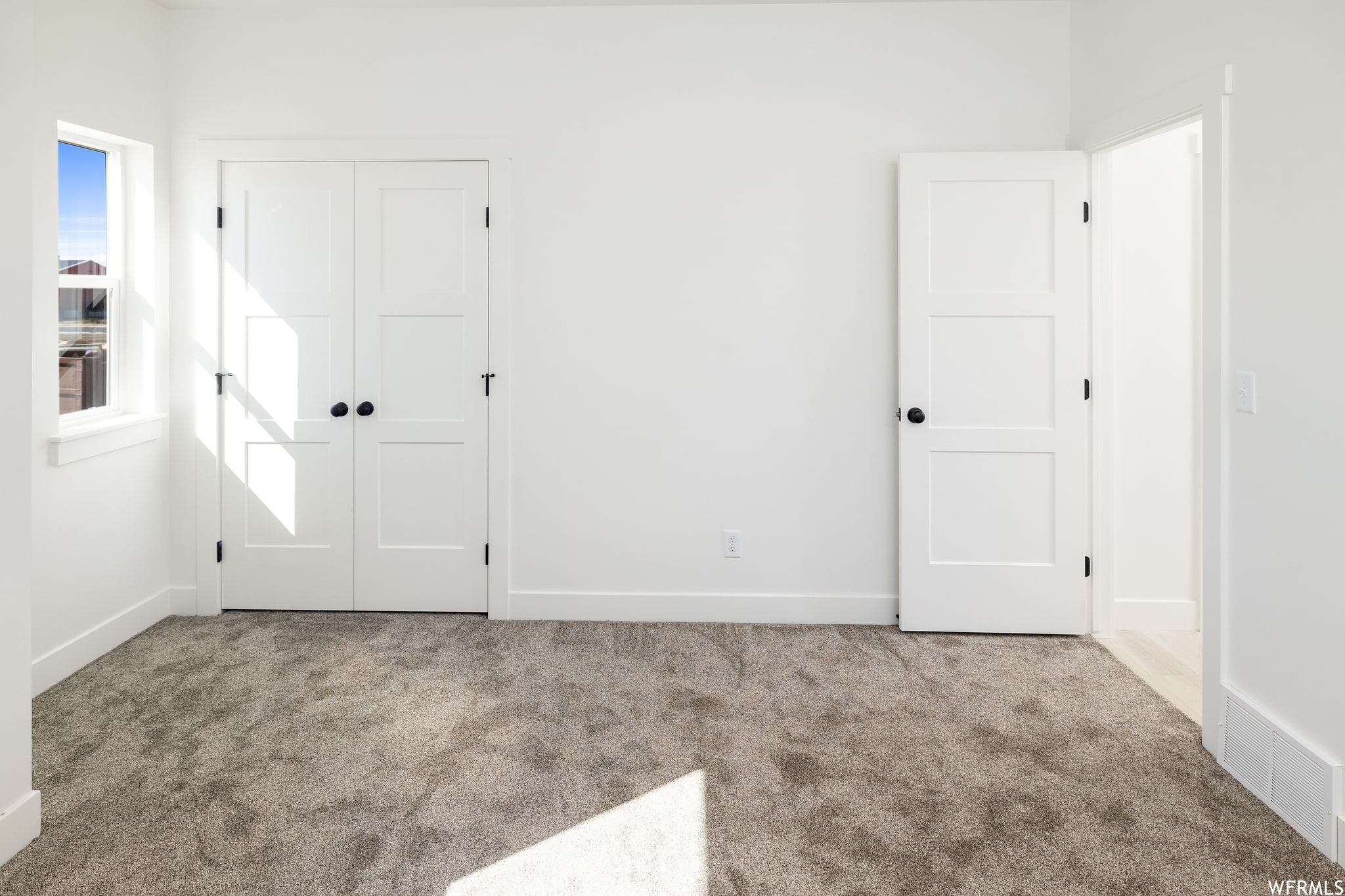 Unfurnished bedroom with a closet and carpet floors