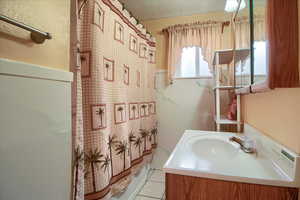 Full bathroom featuring vanity and curtained shower