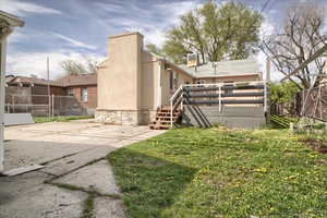 Back of property with stucco siding and a deck