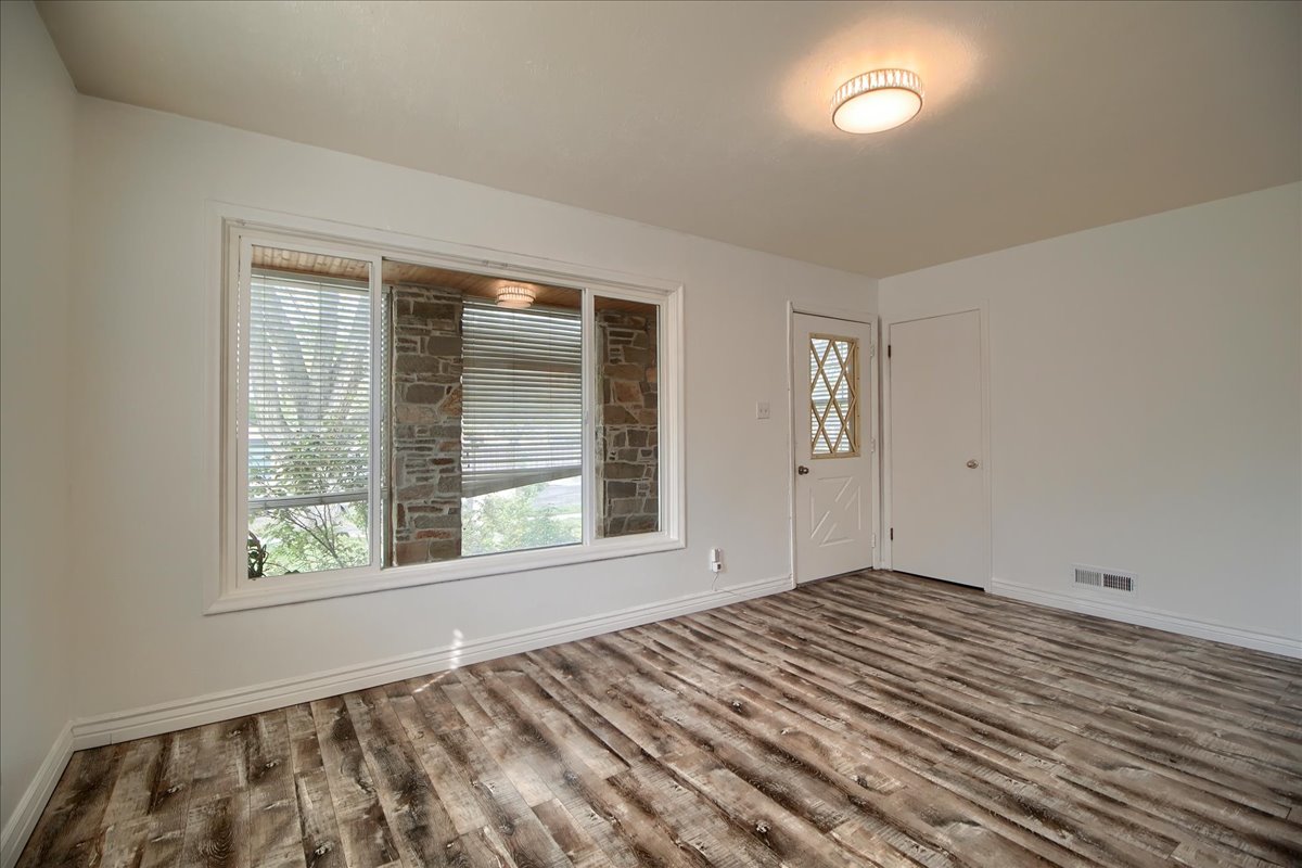 Entrance foyer featuring dark wood finished floors and baseboards