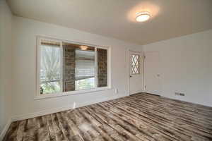 Entrance foyer featuring dark wood finished floors and baseboards