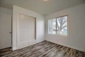 Unfurnished bedroom featuring a closet and wood finished floors