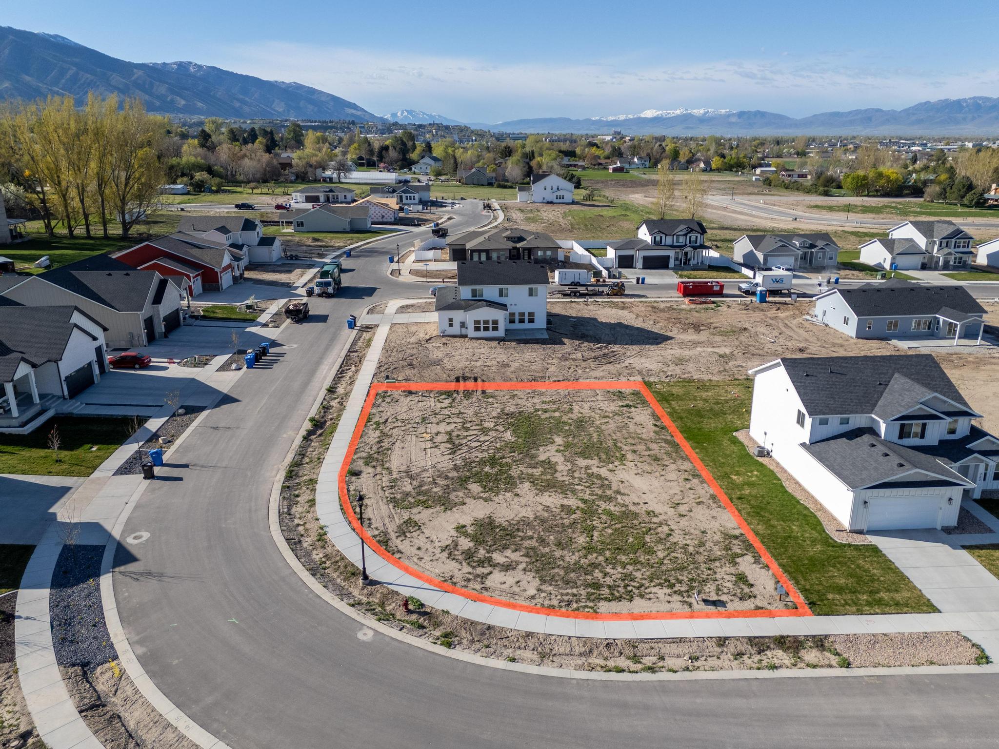 Aerial perspective of suburban area with property boundaries highlighted and mountains