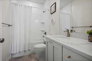 Full bath featuring shower / bath combo and vanity