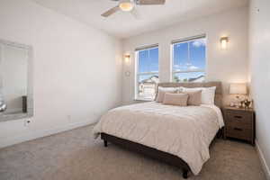 Virtually staged- Carpeted bedroom featuring a ceiling fan and baseboards