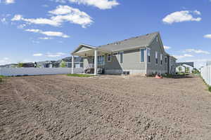 Rear view of house featuring a fenced backyard, a patio, and a residential view