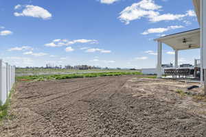 View of yard featuring a ceiling fan