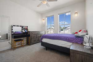 Actual bedroom furniture.Bedroom with light colored carpet and a ceiling fan