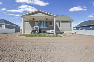 Rear view of house with a ceiling fan and a patio
