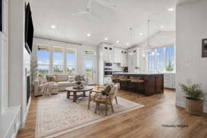 Expansive open-concept living space with wood-finish flooring