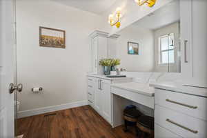 Bathroom featuring vanity and dark wood-style flooring