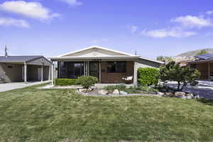 Ranch-style house featuring a front lawn, brick siding,