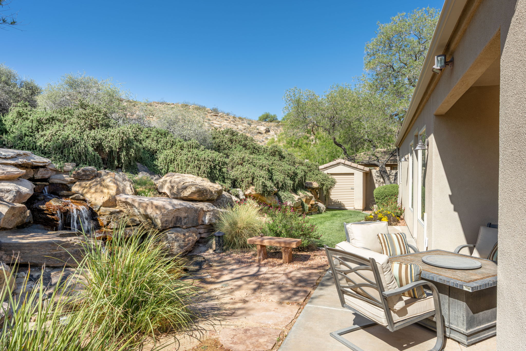 View of patio with a shed