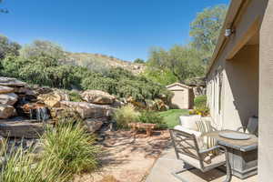 View of patio with a shed