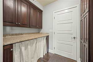 Laundry room featuring dark wood finished floors