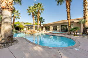 Community pool with a community hot tub and a patio area