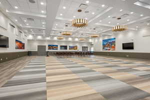 Building lobby featuring recessed lighting, a wainscoted wall, and high coffered ceiling