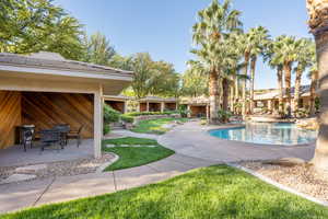 Outdoor pool featuring a patio, a yard, and outdoor dining area