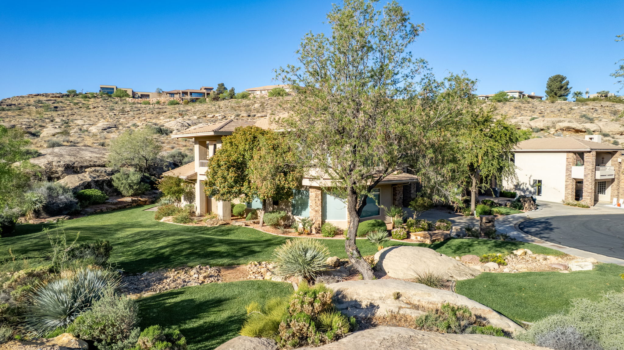 Obstructed view of property with a front yard and stucco siding