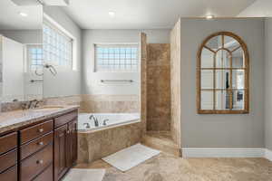 Full bathroom with a walk in shower, vanity, a bath, and recessed lighting