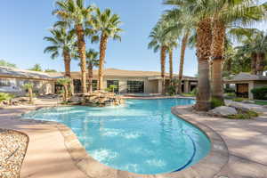 Community pool featuring a community hot tub and a patio area
