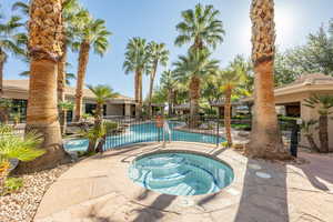 Community pool featuring a patio area and a hot tub