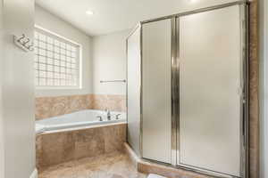 Full bath featuring a shower stall, a bath, and recessed lighting