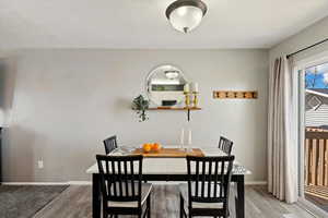 Dining area featuring light wood-type flooring and baseboards