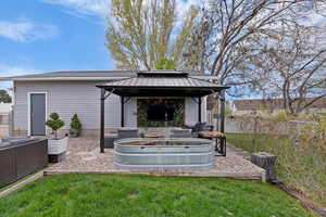 View of yard with a gazebo, an outdoor living space with a fire pit, and a patio